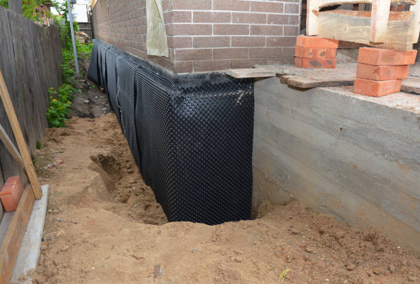 Happy homeowners after waterproofing job in Milton Center